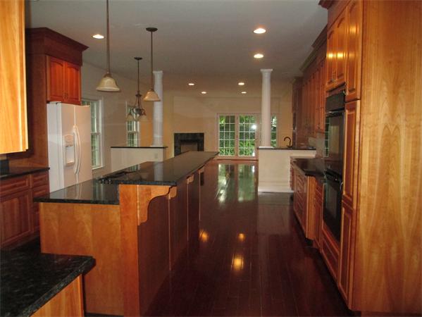 798 Worcester Street Wellesley, MA 02482 - Photo 4 of 20 a kitchen with stainless steel appliances granite countertop a refrigerator a oven and a sink with wooden floor