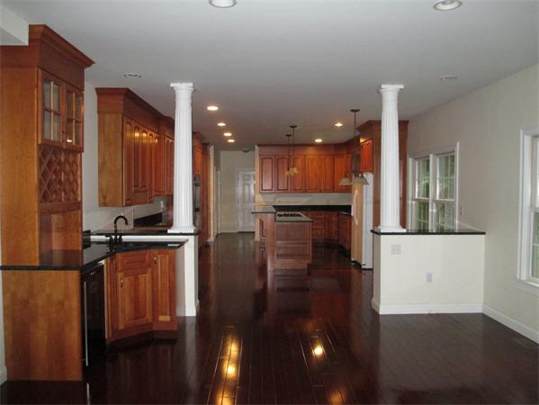 798 Worcester Street Wellesley, MA 02482 - Photo 5 of 20 a kitchen with stainless steel appliances kitchen island granite countertop a refrigerator a stove and a sink with granite countertops