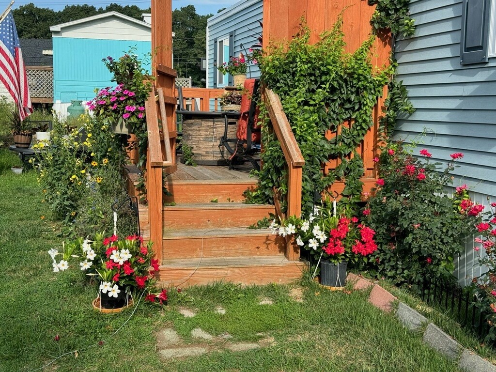 194 Lafayette Road, Unit 11N Salisbury, MA 01952 - Photo 2 of 17 a view of a house with a big yard and potted plants