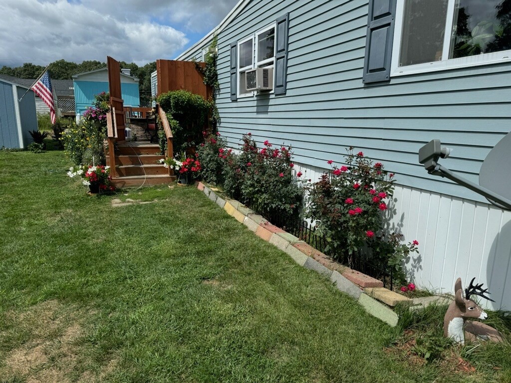 194 Lafayette Road, Unit 11N Salisbury, MA 01952 - Photo 3 of 17 a view of a house with a backyard and garden