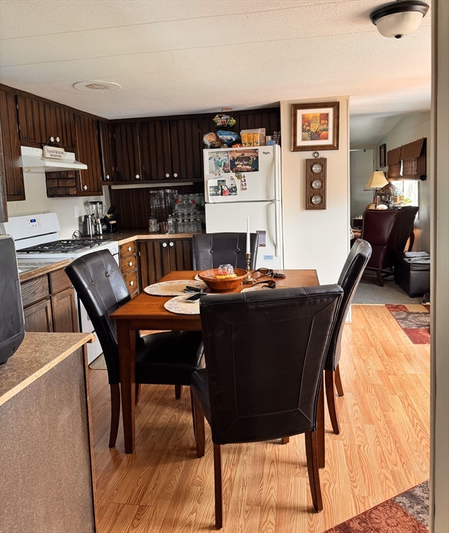 194 Lafayette Road, Unit 11N Salisbury, MA 01952 - Photo 9 of 17 a living room with a couch and a dining table with wooden floor