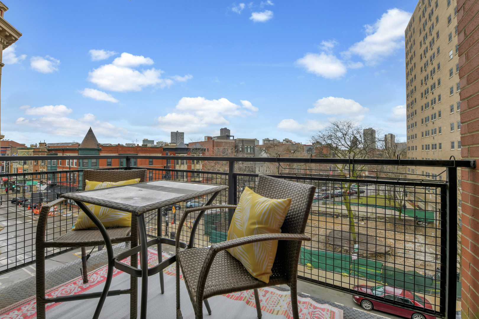 3260 North Clark Street, Unit 407 Chicago, IL 60657 - Photo 15 of 18 a view of a chairs and table on the terrace