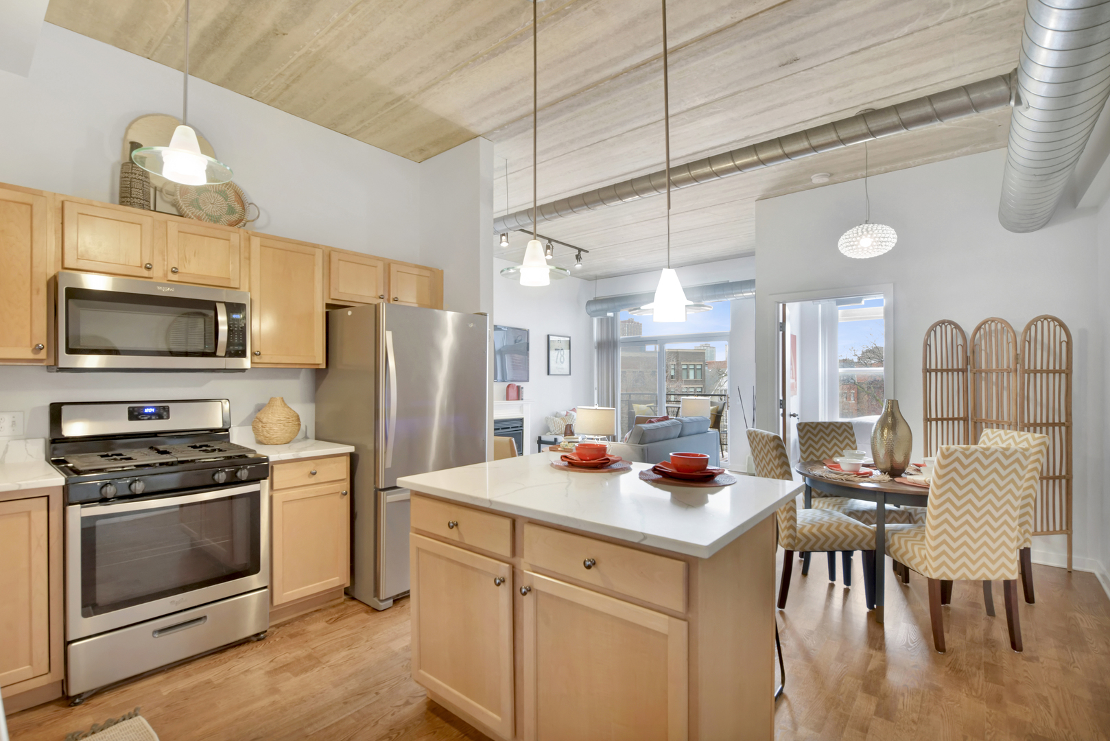 3260 North Clark Street, Unit 407 Chicago, IL 60657 - Photo 4 of 18 a kitchen with a table chairs stove and refrigerator