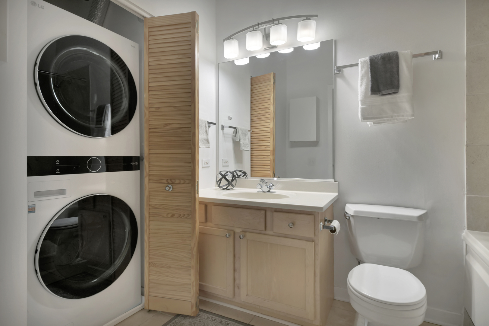 3260 North Clark Street, Unit 407 Chicago, IL 60657 - Photo 10 of 18 a bathroom with a toilet sink and mirror