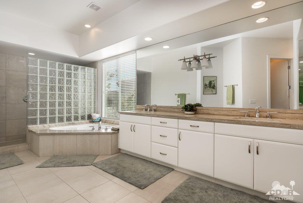 19 Napoleon Road Rancho Mirage, CA 92270 - Photo 14 of 41 a bathroom with a granite countertop bathtub sink vanity and mirror