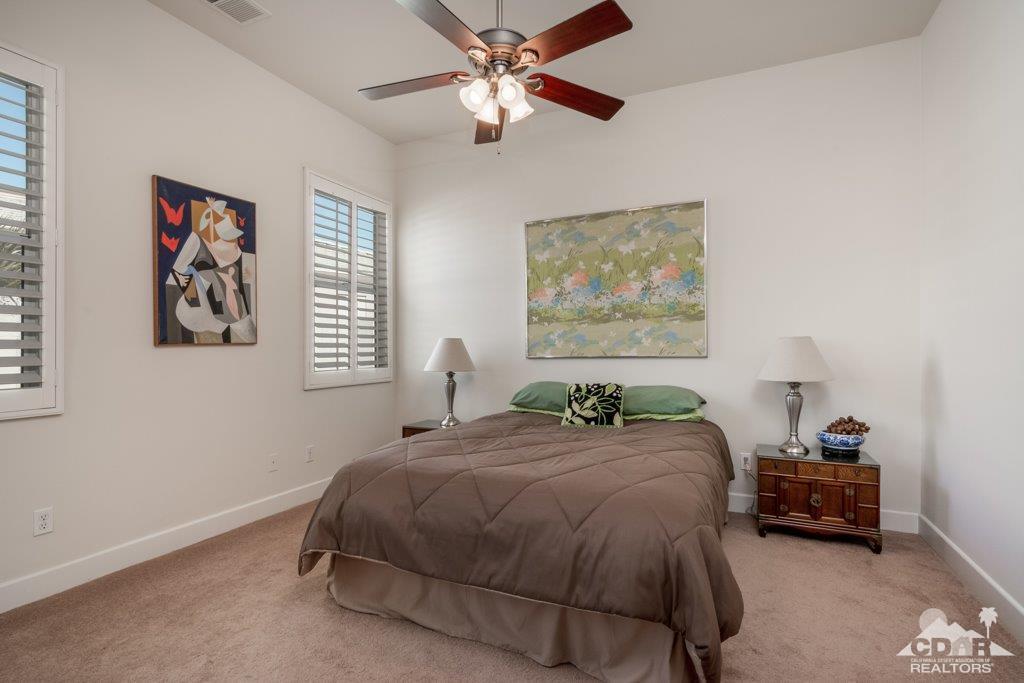 19 Napoleon Road Rancho Mirage, CA 92270 - Photo 16 of 41 a bedroom with a bed and a painting on the wall