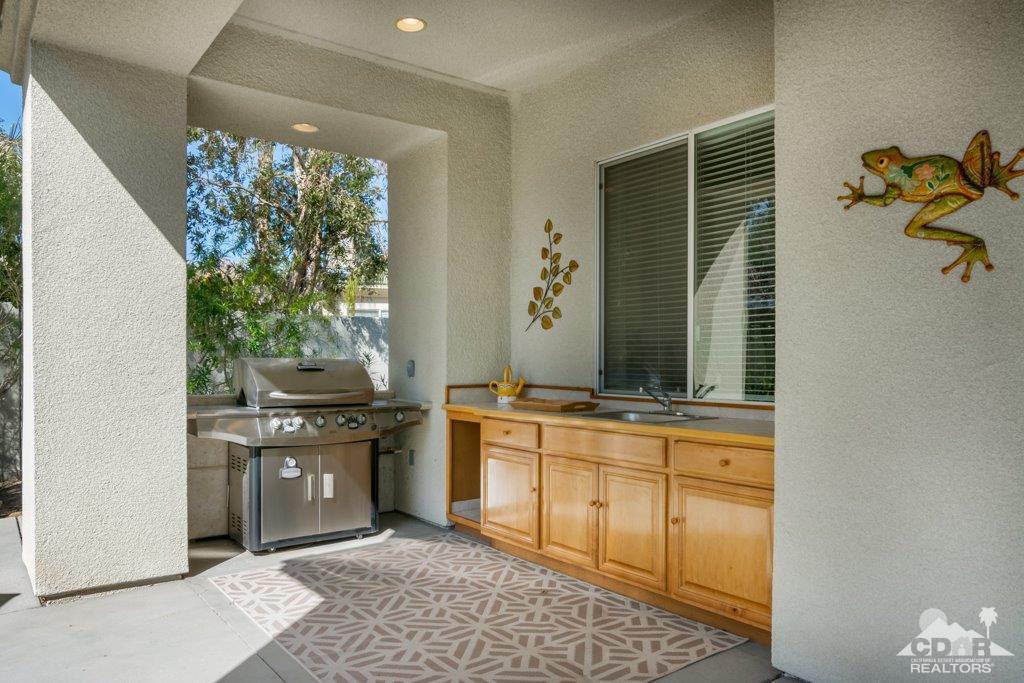 19 Napoleon Road Rancho Mirage, CA 92270 - Photo 26 of 41 a kitchen with stainless steel appliances granite countertop a stove a sink and a microwave