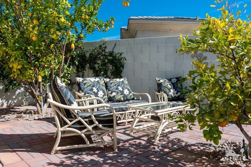19 Napoleon Road Rancho Mirage, CA 92270 - Photo 30 of 41 a patio with table and chairs and potted plants