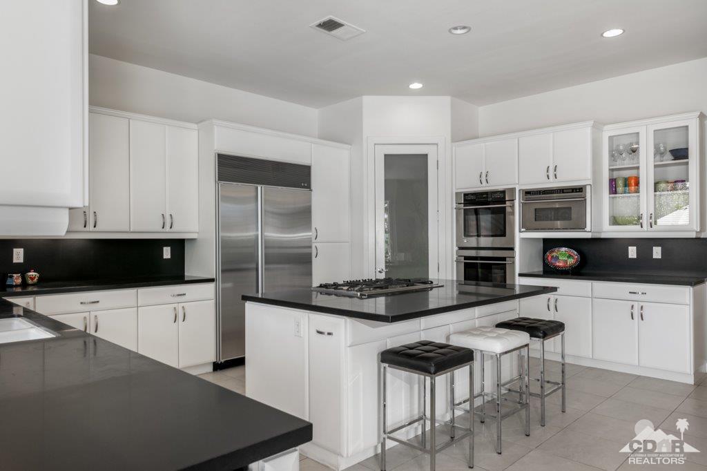 19 Napoleon Road Rancho Mirage, CA 92270 - Photo 7 of 41 a kitchen with stainless steel appliances a stove a sink a microwave and a refrigerator