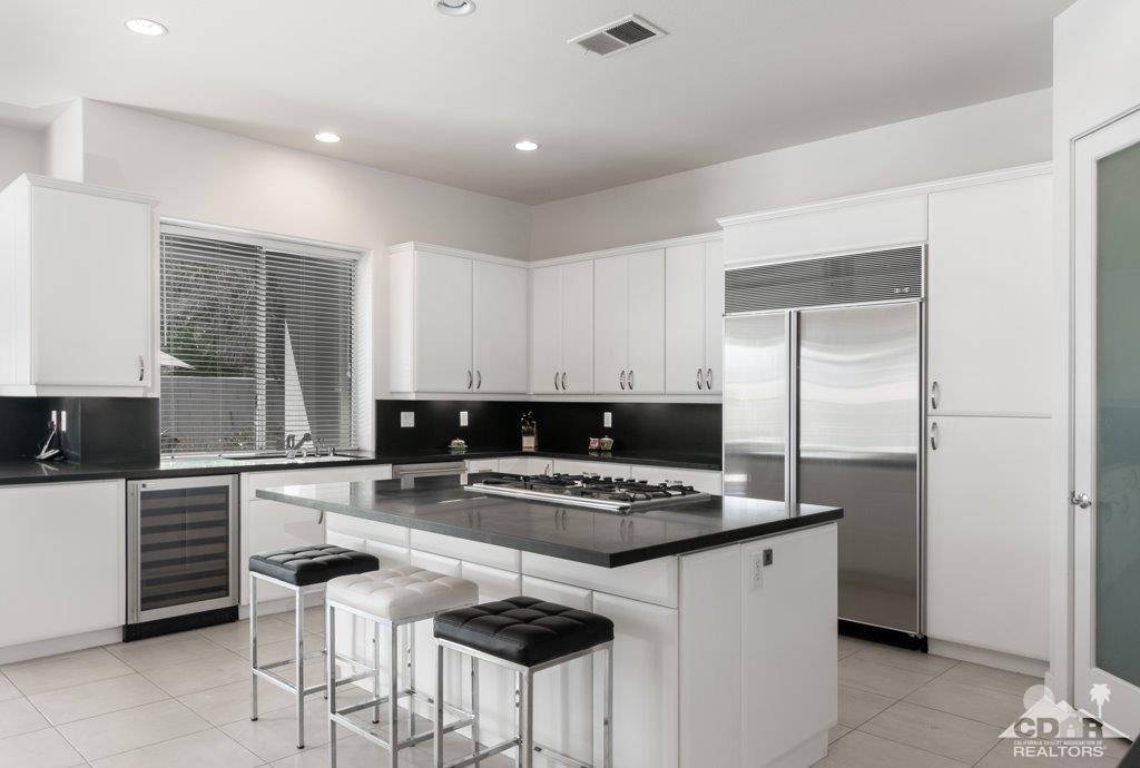 19 Napoleon Road Rancho Mirage, CA 92270 - Photo 8 of 41 a kitchen with stainless steel appliances a stove a sink and a refrigerator