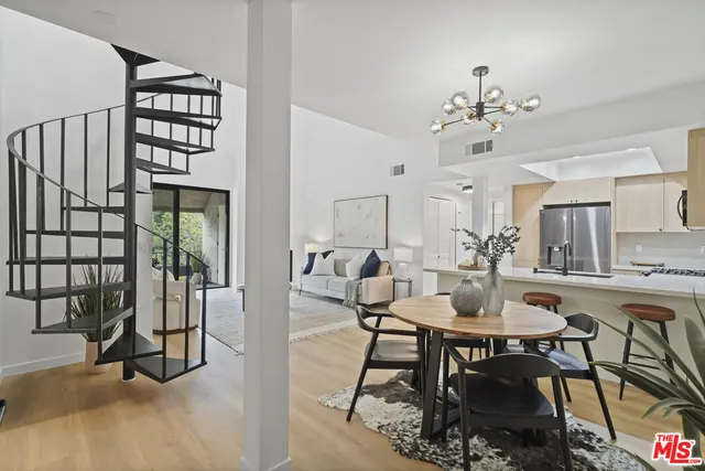 a view of a dining room with furniture and chandelier