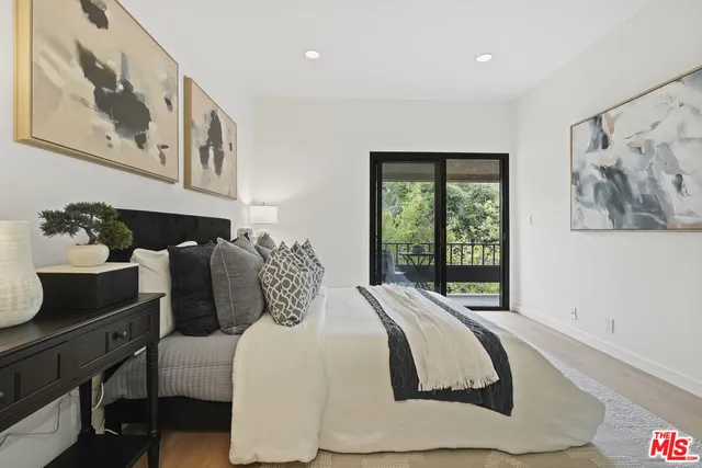 a bedroom with a large bed and a large window