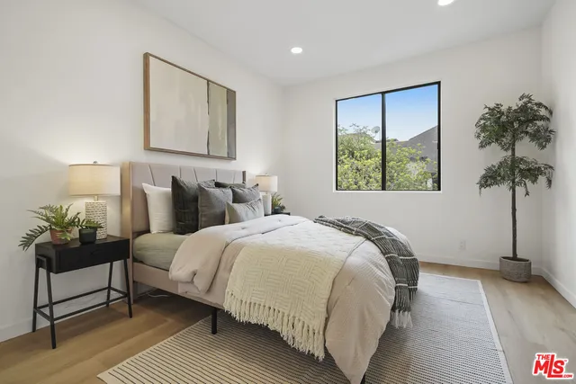 a bedroom with a bed and lamp