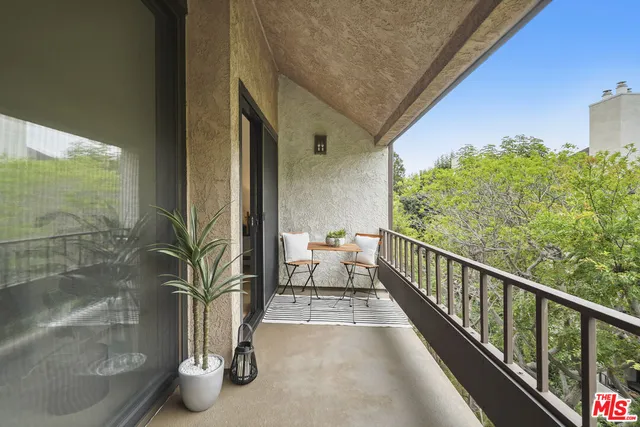 a view of a balcony with chairs
