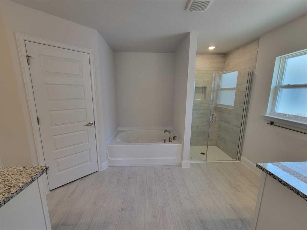 4626 Southwest 103rd Street Road Ocala, FL 34476 - Photo 20 of 29 a bathroom with a bathtub and shower
