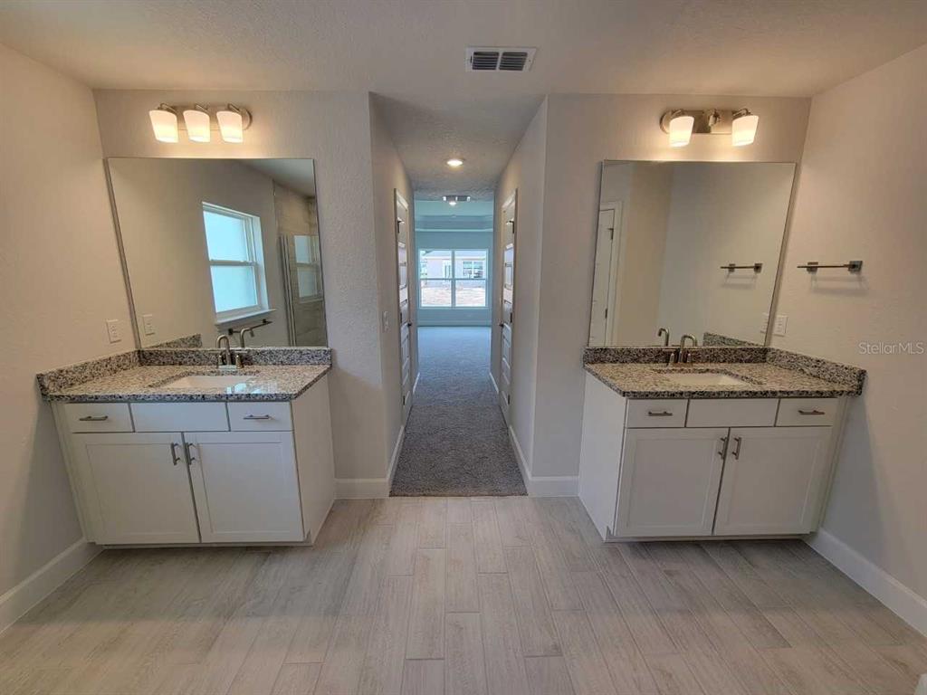 4626 Southwest 103rd Street Road Ocala, FL 34476 - Photo 21 of 29 a bathroom with granite countertop a sink and a mirror