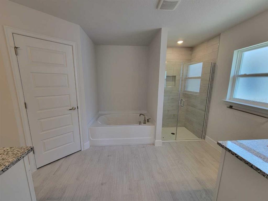 4626 Southwest 103rd Street Road Ocala, FL 34476 - Photo 22 of 29 a bathroom with a bathtub and a shower
