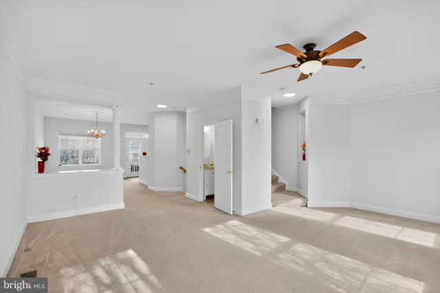 a view of a livingroom with a ceiling fan and window