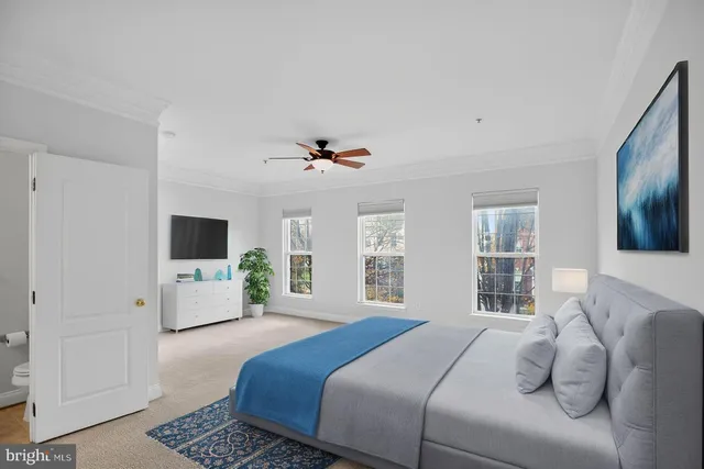 an empty room with windows and ceiling fan