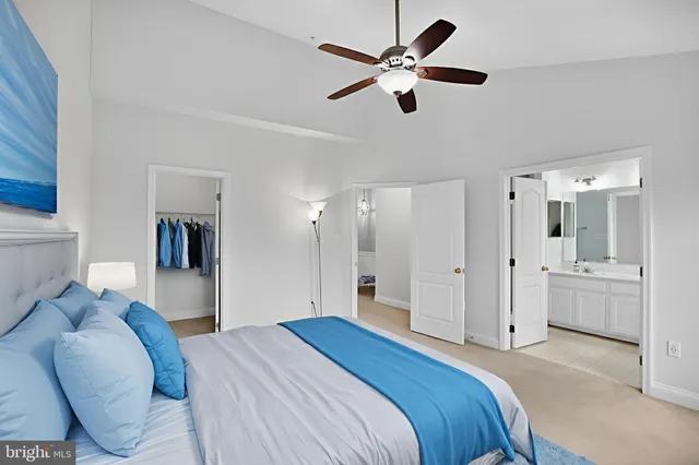 a view of a livingroom with a chandelier fan and a kitchen