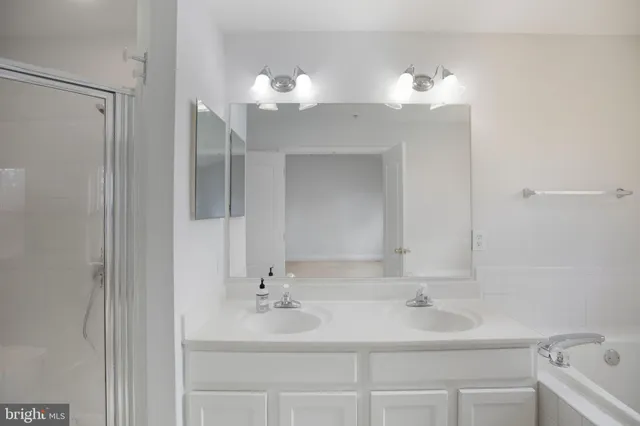 a bathroom with a tub sink and a mirror