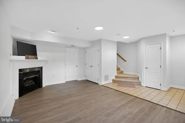 a view of a livingroom with an empty space and a fireplace