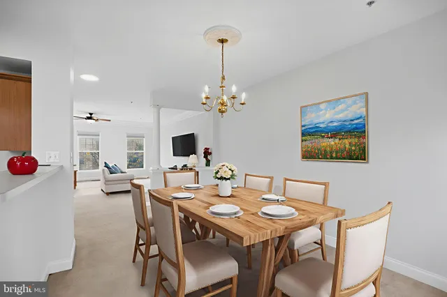 a view of a dining room with furniture and chandelier