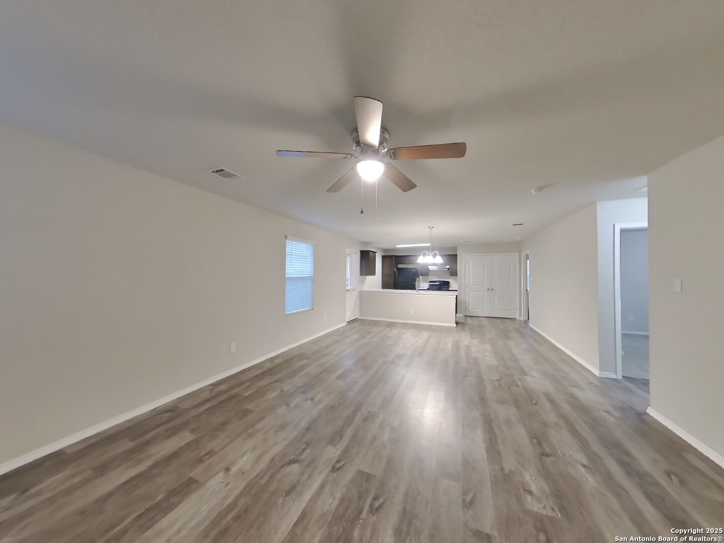 8718 Segura Way San Antonio, TX 78254 - Photo 2 of 16 a view of empty room with wooden floor and ceiling fan