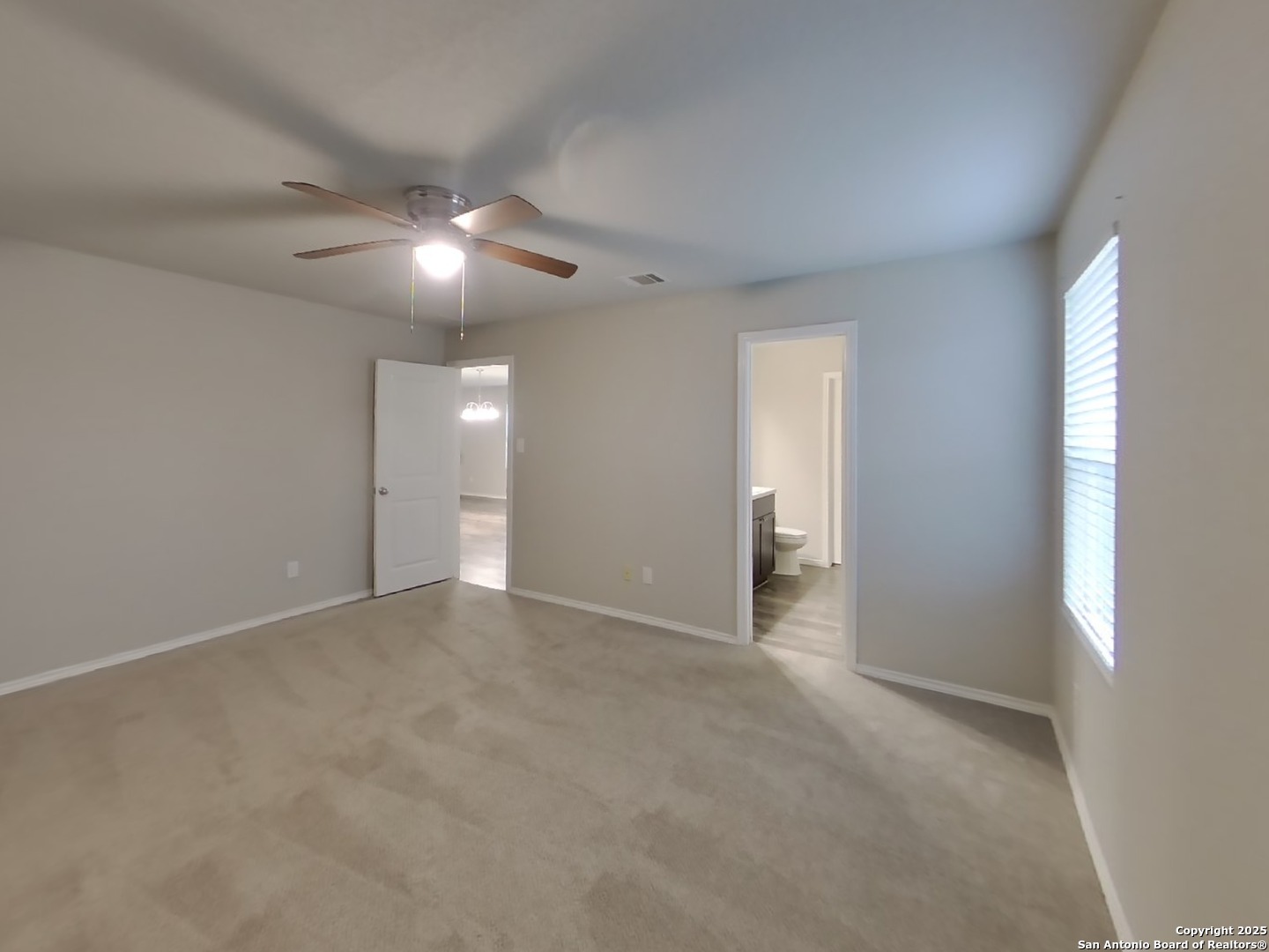 8718 Segura Way San Antonio, TX 78254 - Photo 7 of 16 a view of an empty room with a ceiling fan