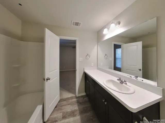 a bathroom with a sink a mirror and a shower