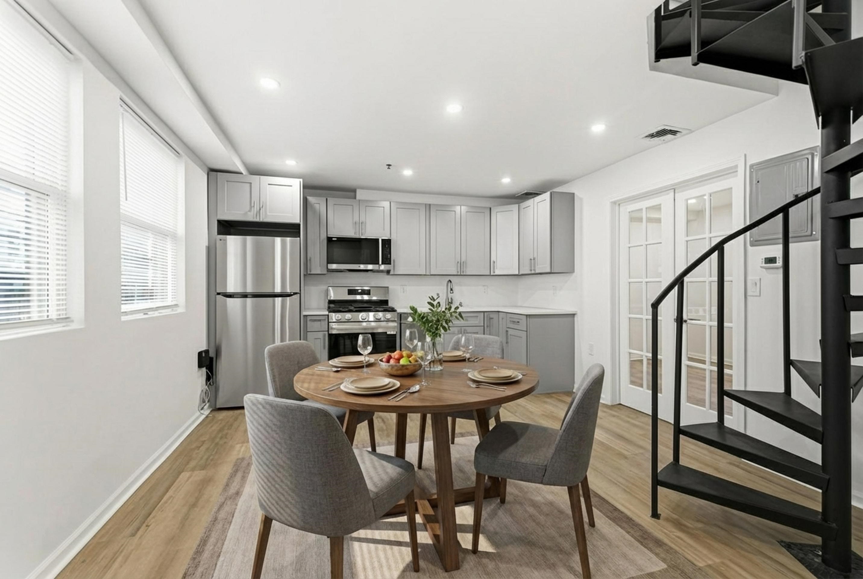 a view of a dining room with furniture and a refrigerator
