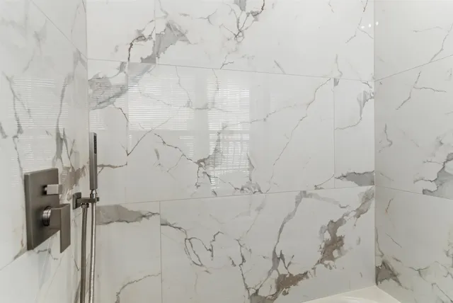 a bathroom with a bathtub sink and mirror