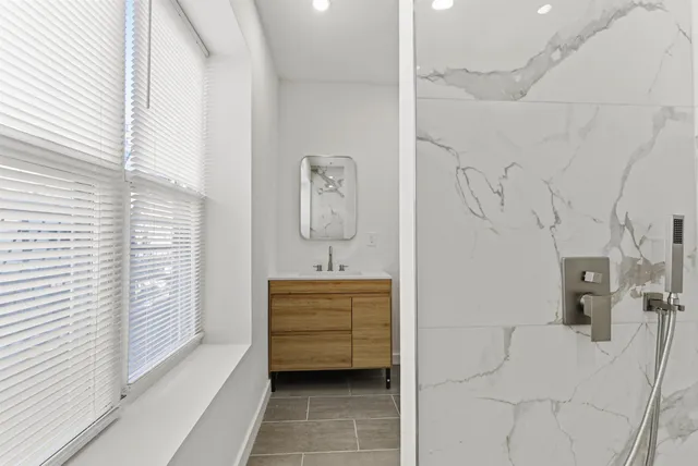 a bedroom with a bed and a large window