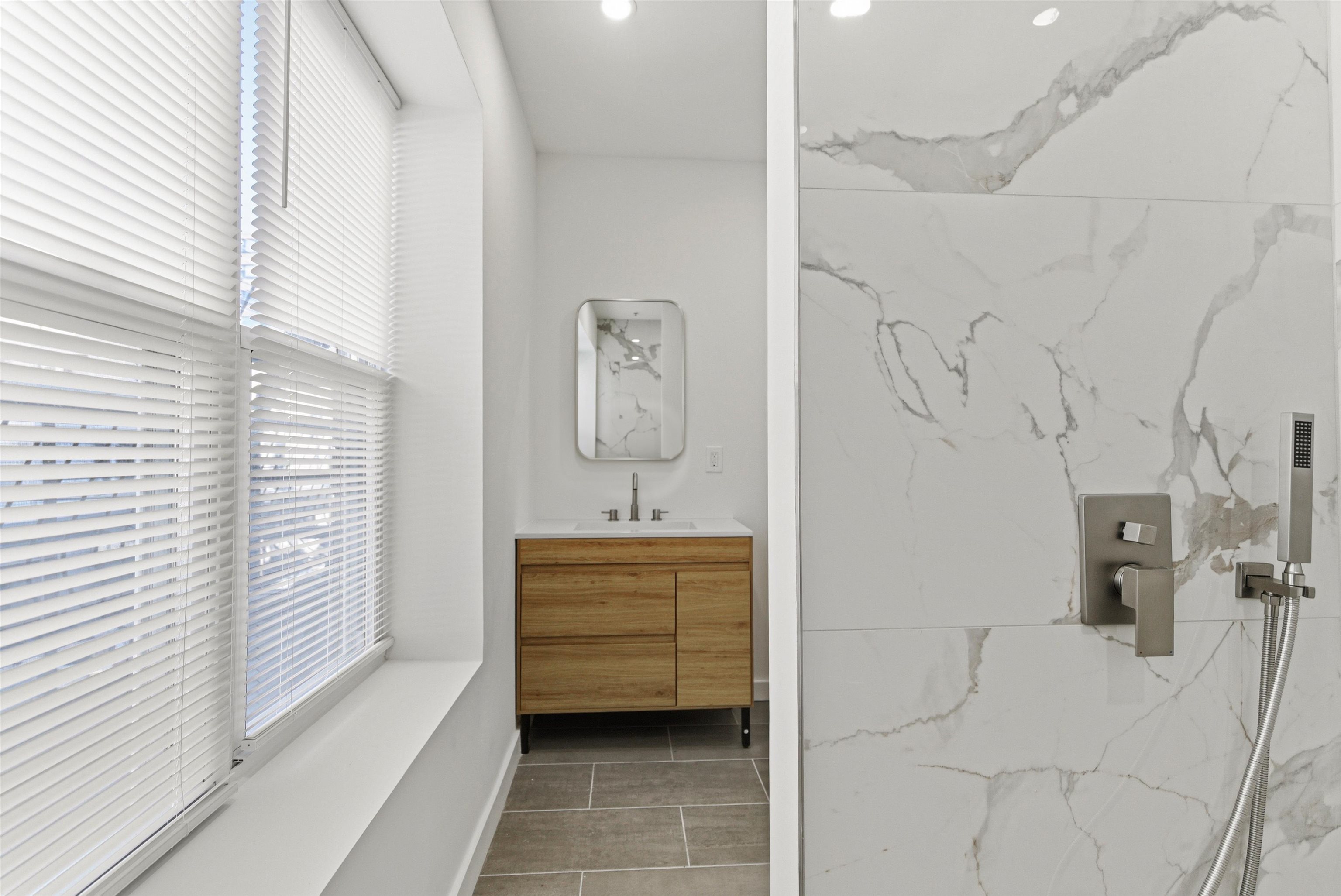 419 5th Street, Unit B Hoboken, NJ 07030 - Photo 14 of 19 a bathroom with a bathtub sink and mirror