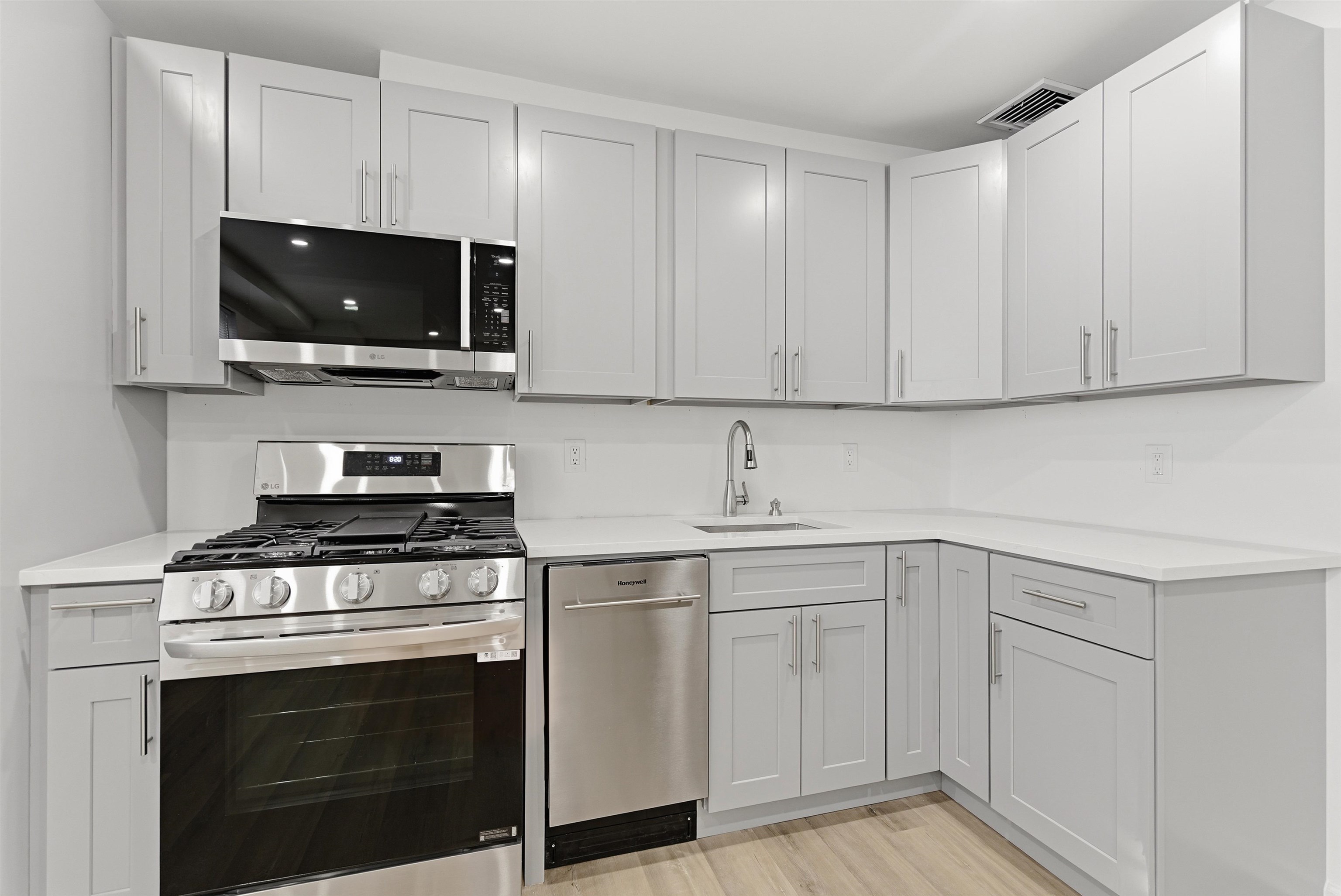 419 5th Street, Unit B Hoboken, NJ 07030 - Photo 2 of 19 a kitchen with white cabinets and stainless steel appliances