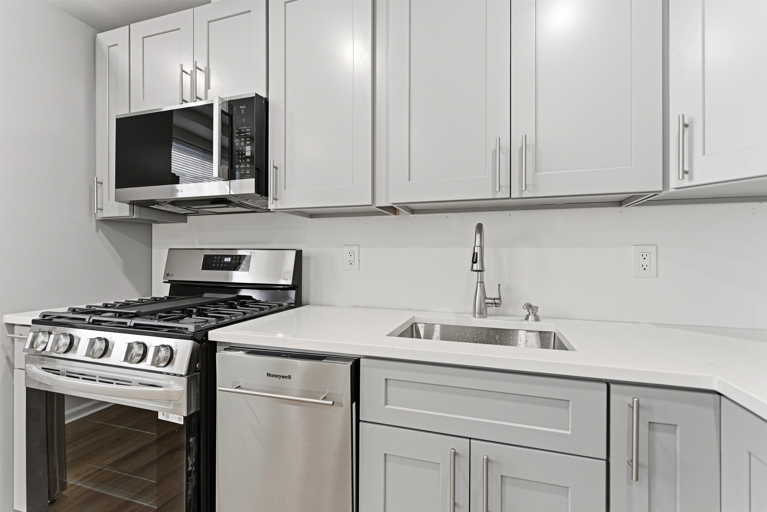 419 5th Street, Unit B Hoboken, NJ 07030 - Photo 3 of 19 a kitchen with stainless steel appliances granite countertop grey cabinets a stove a sink and dishwasher