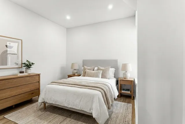 a bedroom with a bed and a mirror