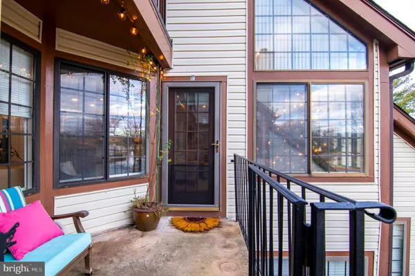 a view of a porch with furniture and front door