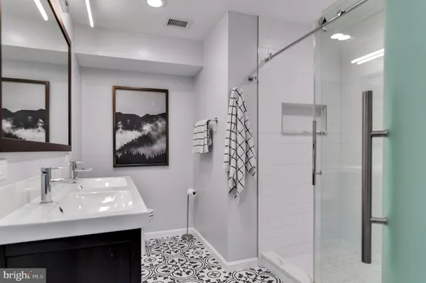 a bathroom with a sink a toilet and shower