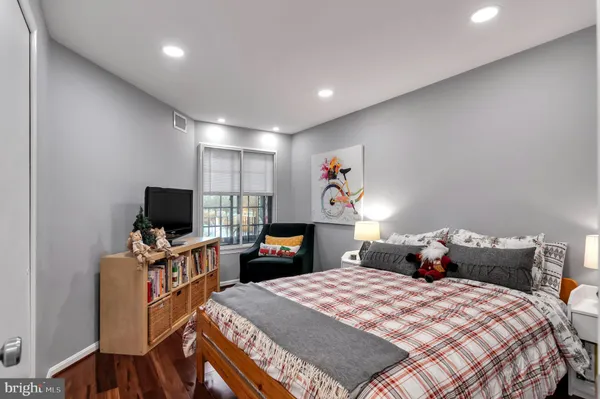 a bathroom with a toilet sink vanity and mirror