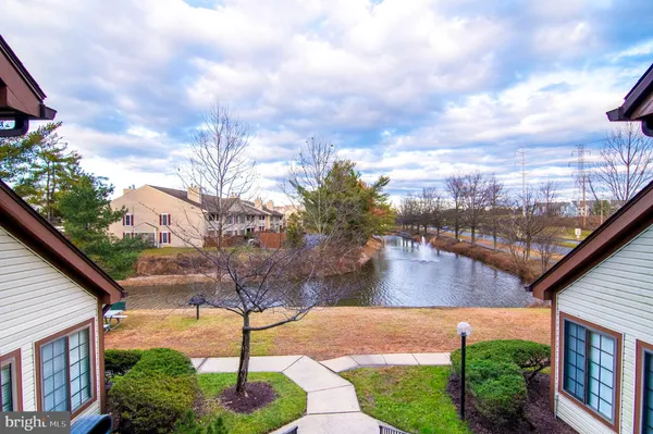 a view of a lake with a yard from a balcony