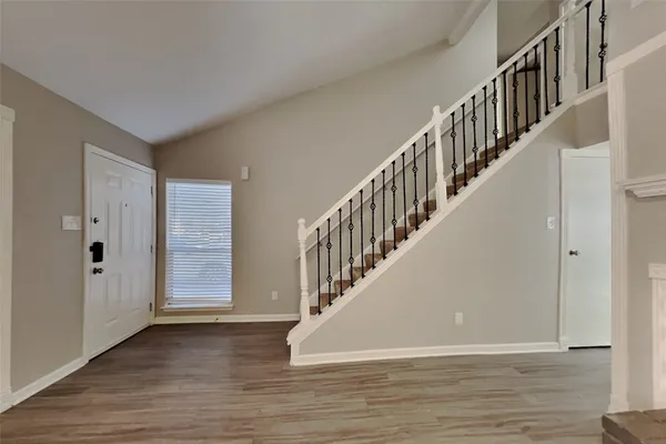 a view of staircase with white walls and windows