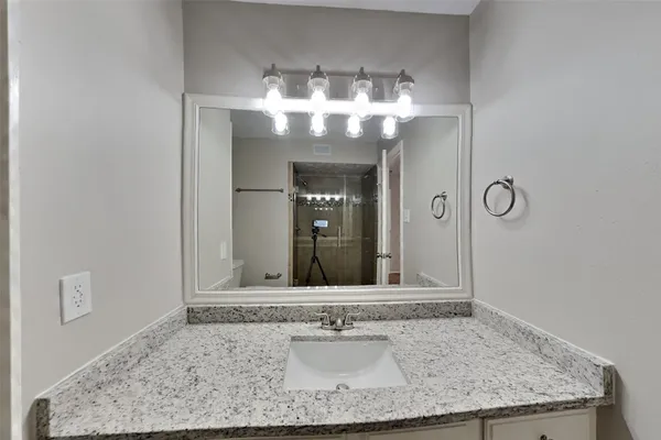 a bathroom with a glass door shower