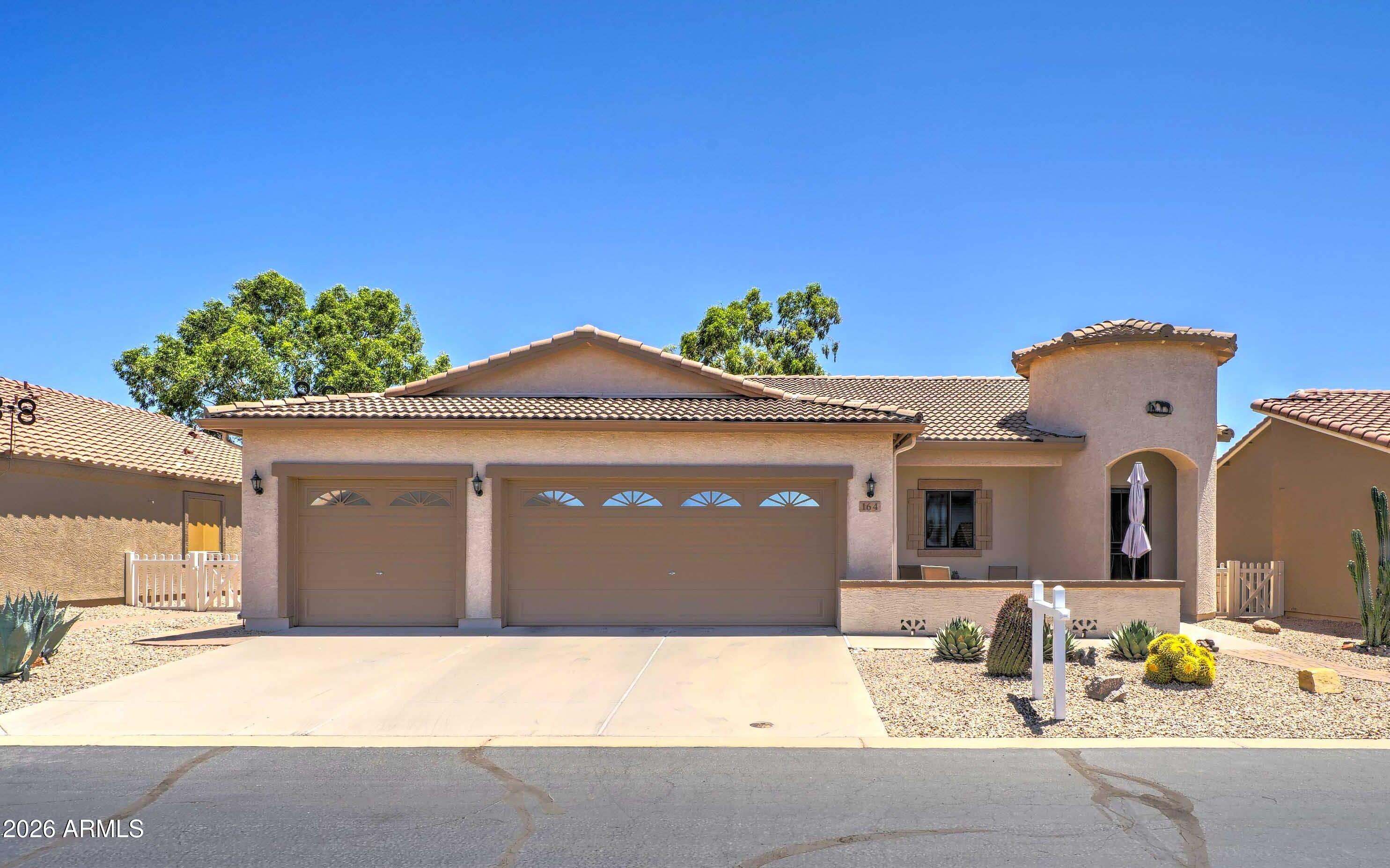 2101 South Meridian Road, Unit 164 Apache Junction, AZ 85120 - Photo 1 of 56 a front view of a house with a yard