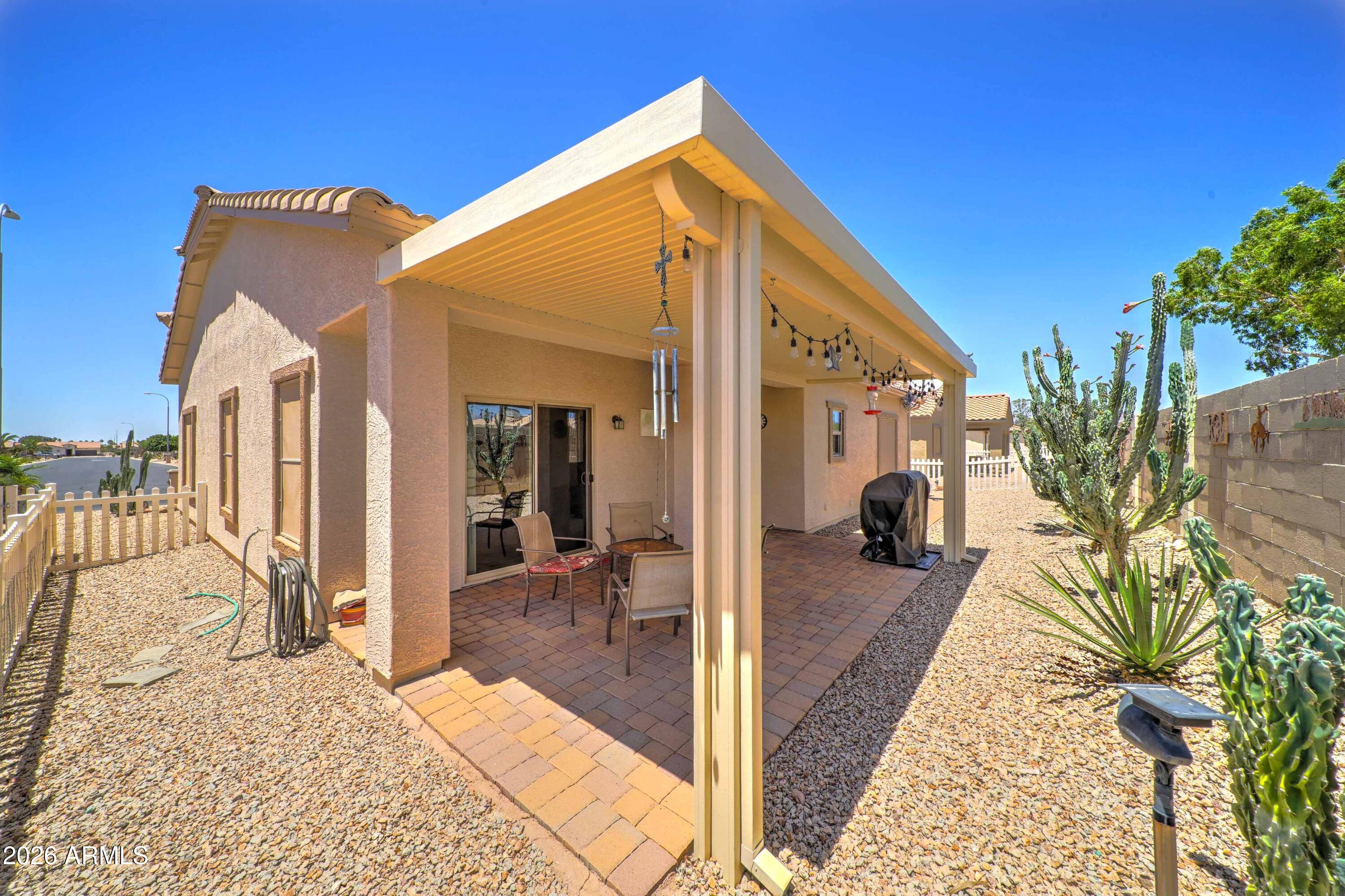 2101 South Meridian Road, Unit 164 Apache Junction, AZ 85120 - Photo 25 of 56 a front view of a house with a yard