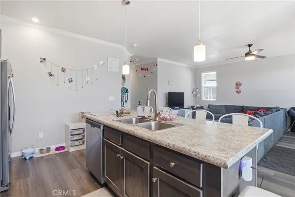 a kitchen with sink and view of living room