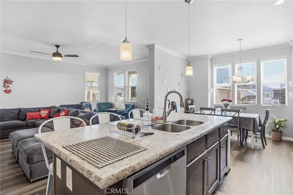 a kitchen with cabinets a refrigerator and chairs