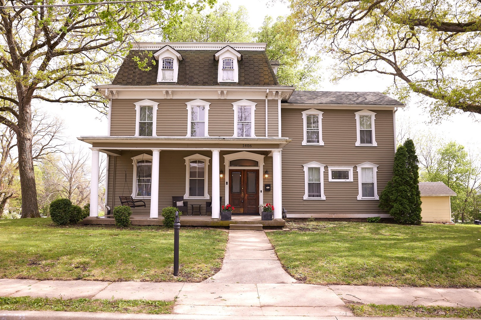 a front view of a house with garden