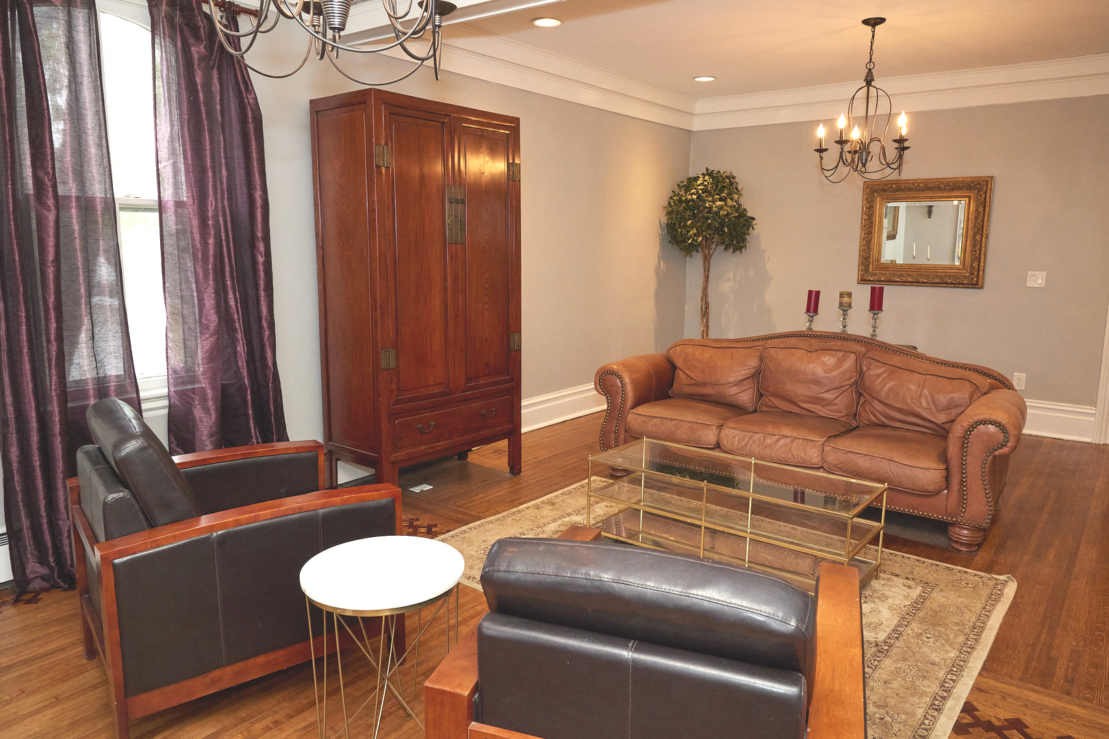 1406 Bluff Street Peru, IL 61354 - Photo 18 of 57 a living room with furniture a chandelier and a mirror