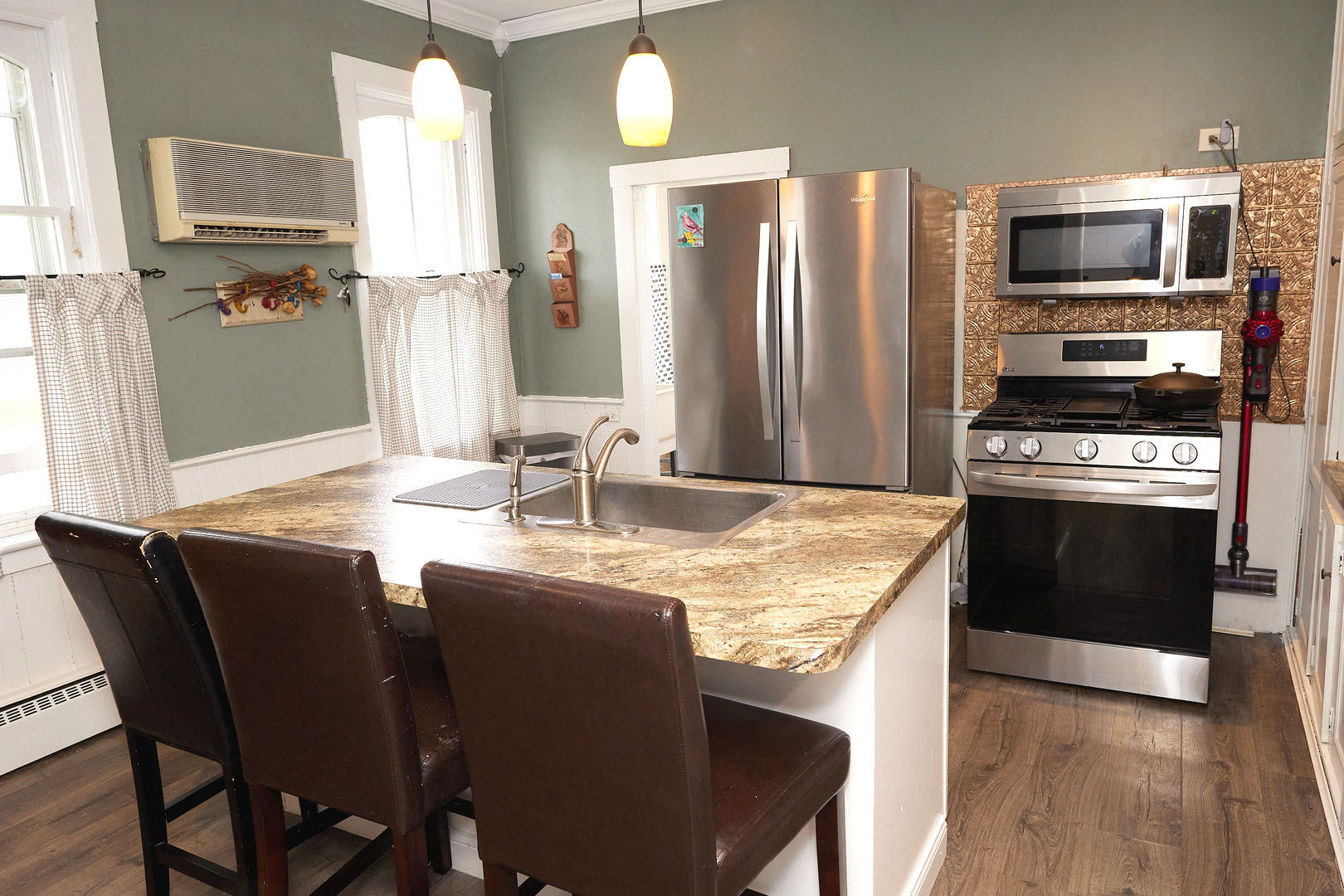 1406 Bluff Street Peru, IL 61354 - Photo 27 of 57 a kitchen with stainless steel appliances granite countertop a kitchen island hardwood floor and a sink